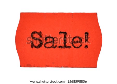Sale word printed with typewriter font on red price tag sticker isolated on white background