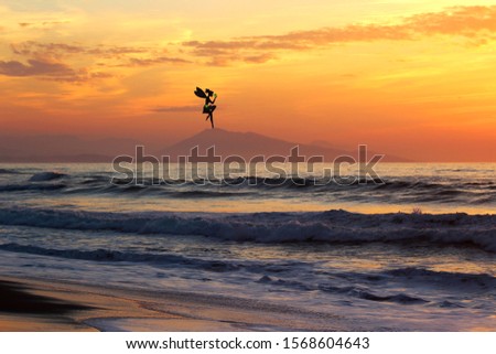Beach landscape in sunset with a fairy on the mountain. Fantasy