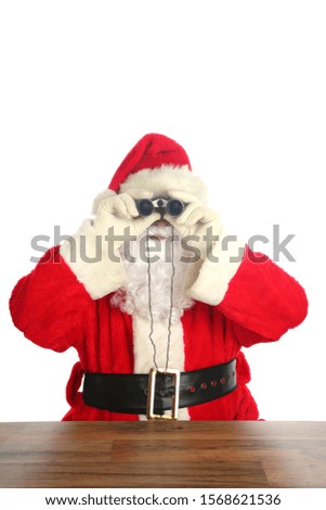 Santa Claus Christmas. Santa Claus looks through his Binoculars to see who has been Naughty or Nice. Isolated on white. Room for text. Santa is watching all year long. Merry Christmas to all.

