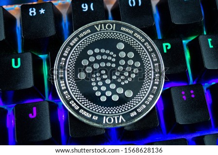Coin cryptocurrency IOTA close-up of the colour-coded keyboard background
