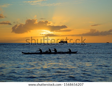 Hawaiian outrigger canoe with paddlers  Royalty-Free Stock Photo #1568656207