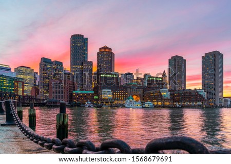Boston skyline and Fort Point Channel at sunset as viewed fantastic twilight or dusk time from Fan Pier Park in Boston, Massachusetts, USA. United state downtown beautiful colorful skyline.