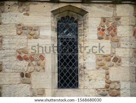 A Close up photo of a window of a church.