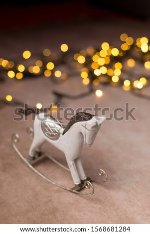 toy wooden horse Christmas lights on the background