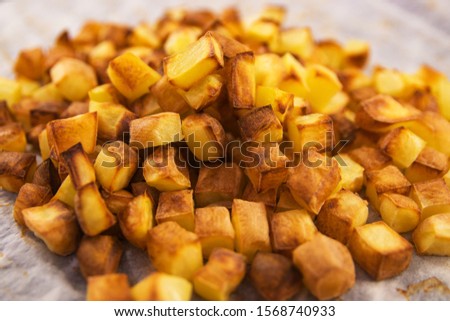 baked diced potato with a golden crust on a lattice close-up shallow depth of field