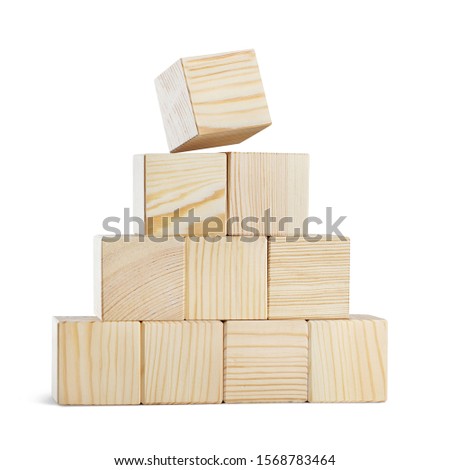 Pyramid of ten wooden cubes, isolated on white background