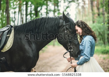 Girl  with a black horse