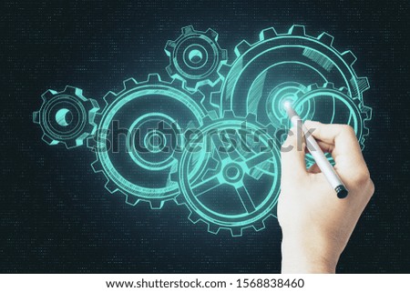 Hand drawing glowing cogwheel sketch on screen. Device and system concept