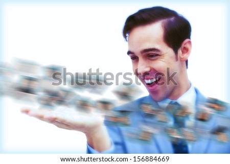 Amused businessman looking at a picture stream on white background