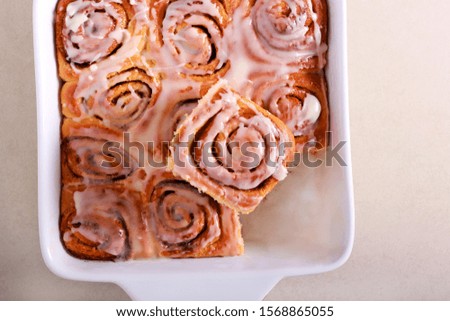 Cinnamon rolls with frosting in baking tin