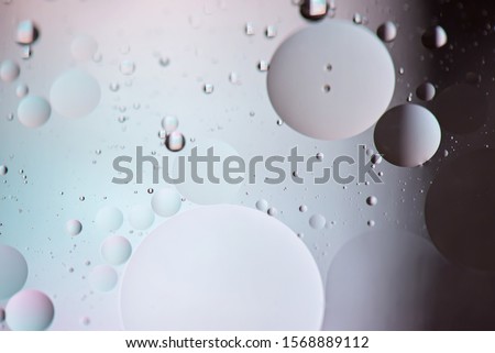 Oil drops in water. Defocused abstract psychedelic pattern image pastel and dark colored. Abstract background with colorful gradient colors. DOF