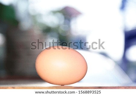 Chicken eggs on a wooden table background with a blurred blue background