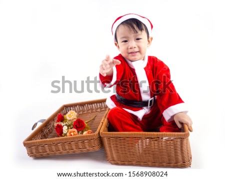 Merry Christmas baby boy is wearing a Santa costume to celebrate Christmas. White background