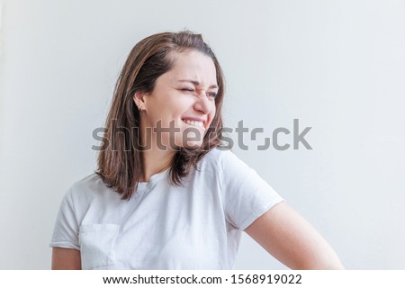 Happy girl smiling. Beauty portrait young happy positive laughing brunette woman on white background isolated. European woman. Positive human emotion facial expression body language.