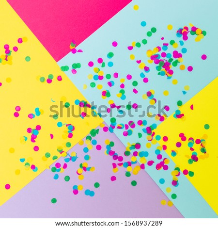 Colorful paper geometric texture with confetti. The concept of the celebration
