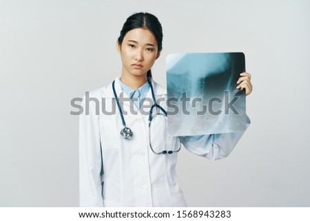 Medical coat x-ray beautiful woman stethoscope gray background