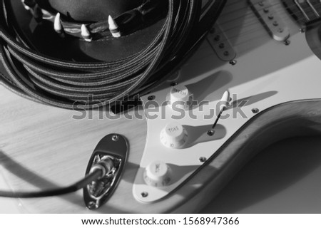vintage guitar and cowboy hat closeup . black and white 