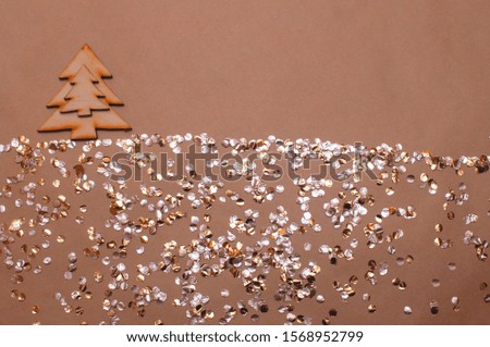 glitter background with sweets and wooden Christmas tree