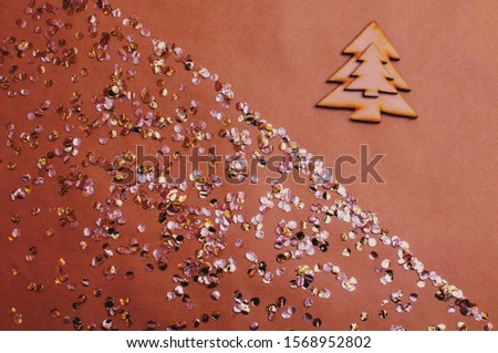 glitter background with sweets and wooden Christmas tree