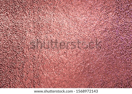 Blurred foil rose gold sparkling shiny paper Christmas holiday. Abstract photo of bokeh gradient pink champagne sparkle glitter texture background.Blur sheet paper light red magenta metal valentine's.