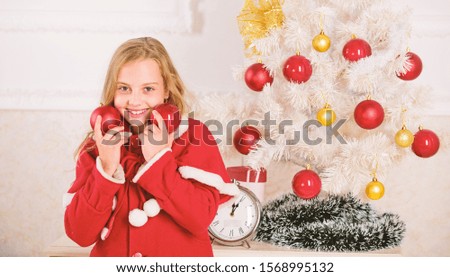 Getting child involved decorating. Girl smiling face hold balls ornaments white interior background. How to decorate christmas tree with kid. Let kid decorate christmas tree. Favorite part decorating.