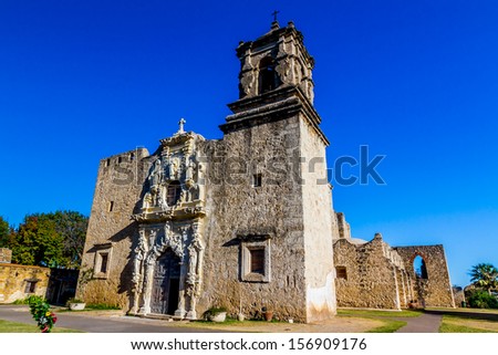 The Historic Old West Spanish Mission San Jose, Founded in 1720, San Antonio, Texas, USA.  Showing dome, bell tower, and one of the old stone water wells.