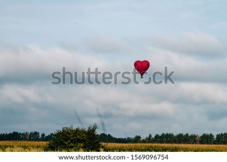 Heart shaped balloon soars in the sky
