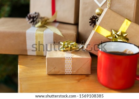 Gift boxes with cup of tea on wooden table. Concept of holiday picture