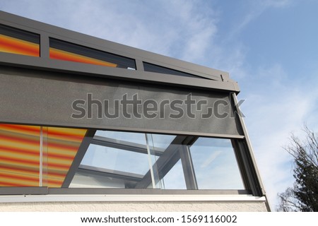 a modern conservatory with awning Royalty-Free Stock Photo #1569116002