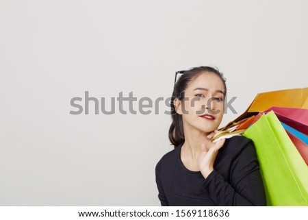 Beautiful young asia woman in black dresswith colorful shopping bags Copy space on white background.