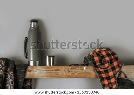 Travel accessories set on wooden shelf and gray background for your text