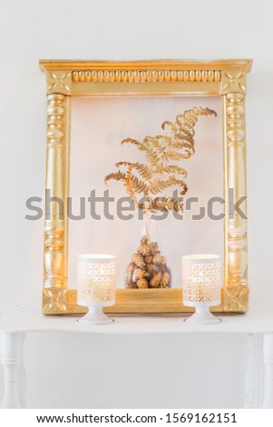 interior decor with burning candles on white wooden shelf