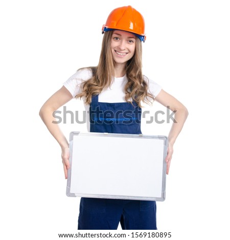 Woman builder with work helmet holds white sign board, big board for advertising sign on white background isolation