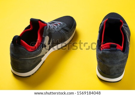 men's sneakers on a bright yellow background. place for text. casual shoes for fall
