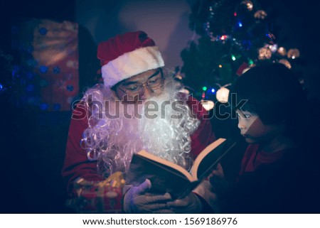 Santa clause reading tale for kid at christmas festival  at home,Thailand people