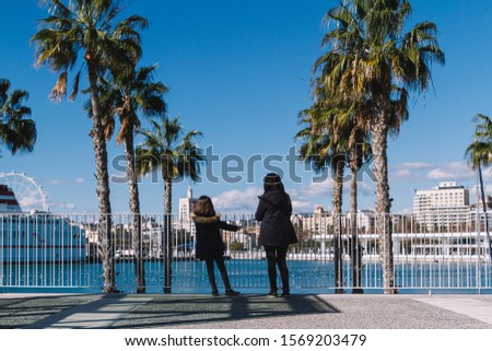 A mother and her daughter enjoying the views from the Muelle Uno Port, in Málaga