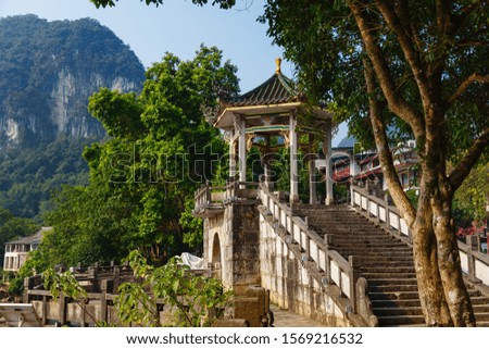 A picturesque place on the background of mountains and pagodas on a clear day, Yangshuo, Guilin, China