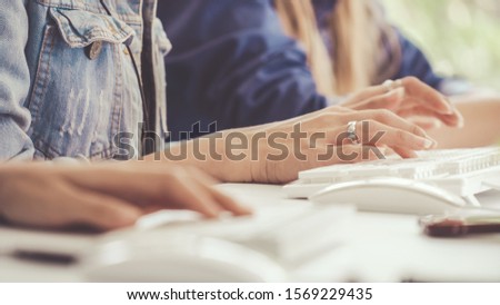 Close up shot of businesswoman hand typing and working on desktop computer on the office desk. Business communication and workplace concept.