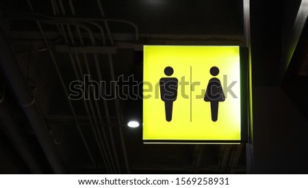 Square lightbox restroom signage hang on wall              