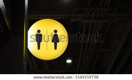 Circle lightbox restroom signage hang on wall 