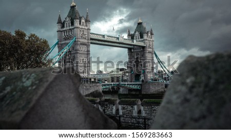 Gloomy rainy day in the heart of London at the Tower Bridge. This famous drawbridge is a classic historic site that is a go-to attraction for decades. Picture taken in the fall season of November.