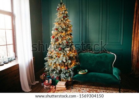 Christmas and new year decorated. Interior room with presents and new year tree
