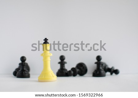 Chess pieces on a white background. Queen and pawns. White paper. The winner of the game.