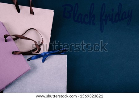 Black Friday shopping sale concept. Paper bags on dark blue background. Flat lay