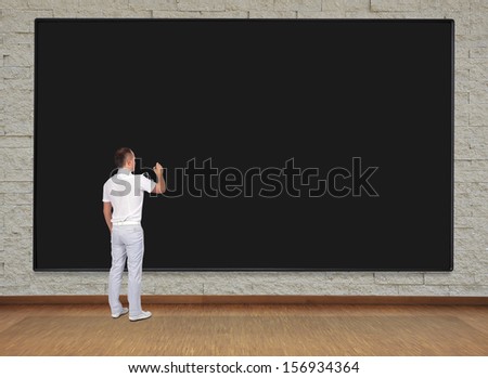 man standing in office and drawing on blackboard