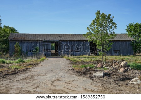 old farm building all forgotten and falling down. Royalty-Free Stock Photo #1569352750
