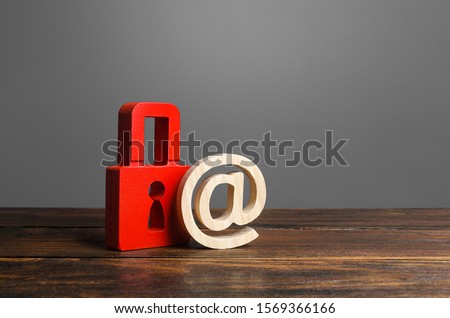 A red padlock and email symbol. preservation of secrets, information and values. Protection and insurance. Hacking attack. Safety of personal data, privacy of users. NSFW. Virus, antivirus Royalty-Free Stock Photo #1569366166