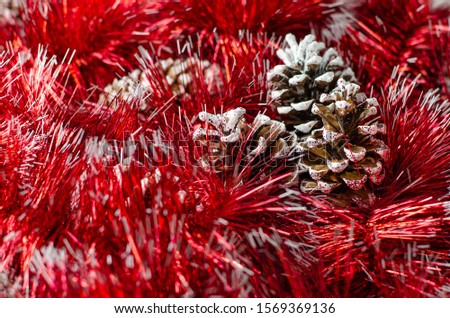 Christmas red garland and pine cones.Christmas background. Selective focus.
