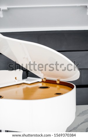 white Grand piano in a beautiful light interior