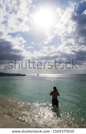 Silhouette of man taking pictures on the beach